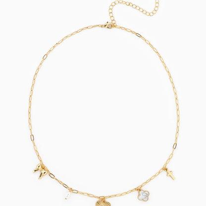 Gold necklace with various charms on a white background