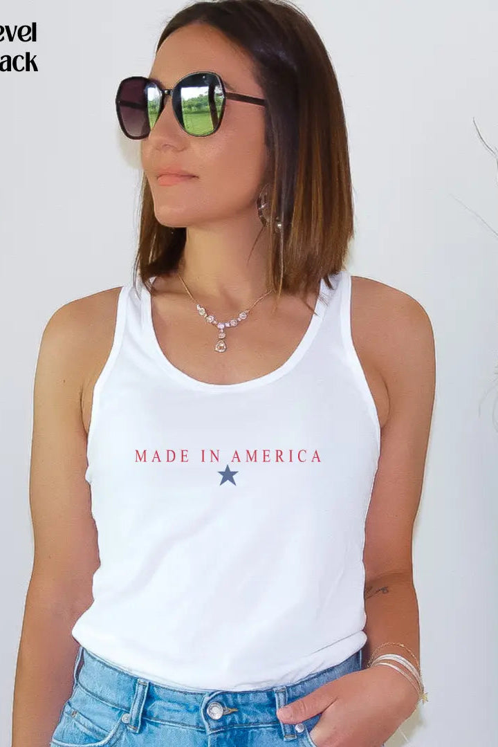 Woman wearing a white tank top with 'Made in America' text, standing against a plain background.