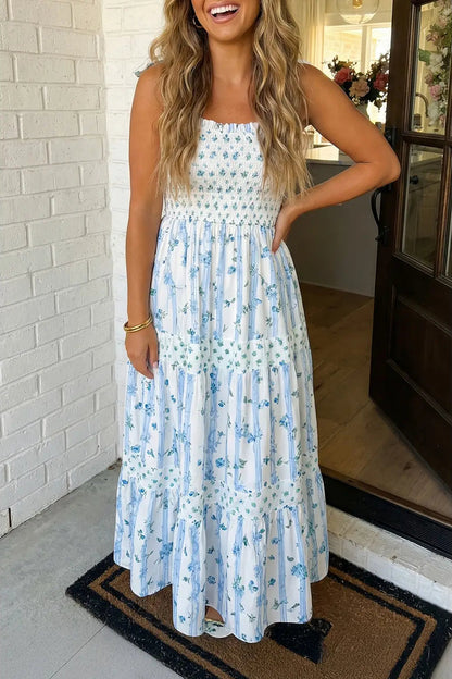 Woman wearing a floral dress standing in a doorway.