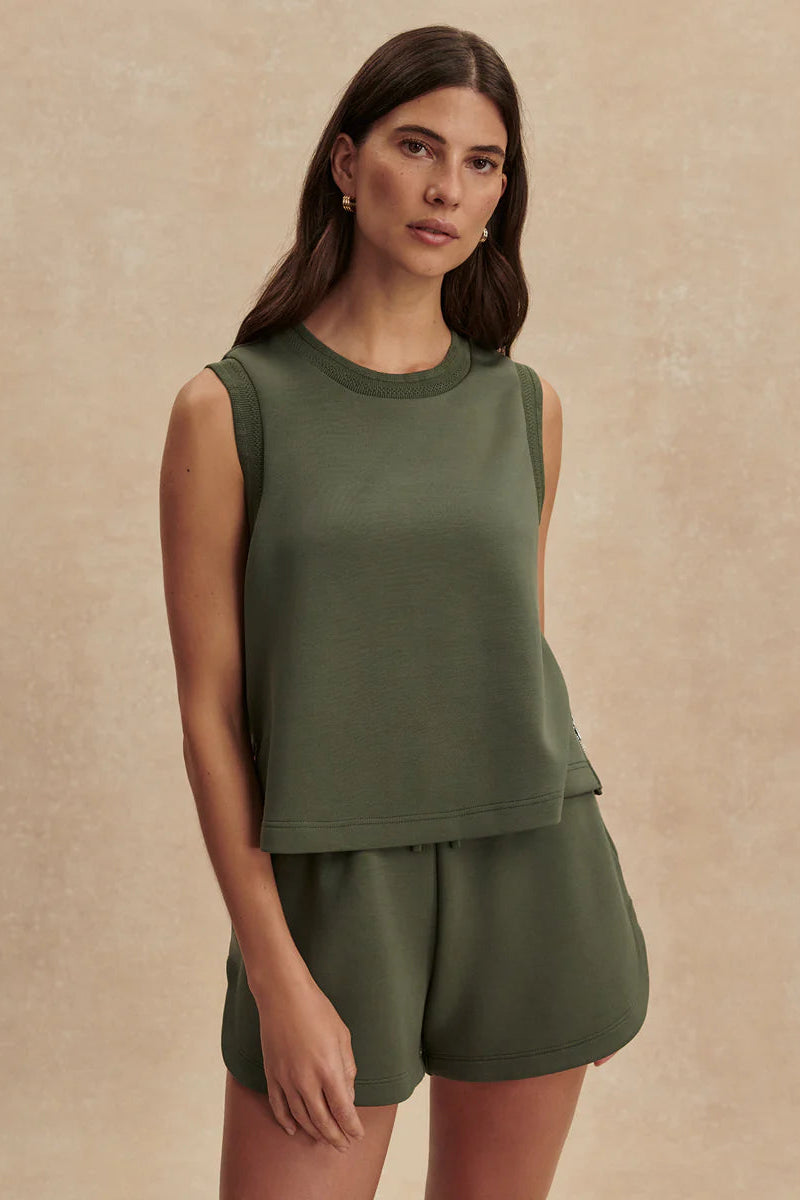 woman wearing green top and green shorts