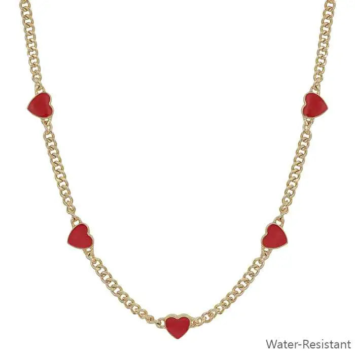 Gold necklace with red heart charms on a white background