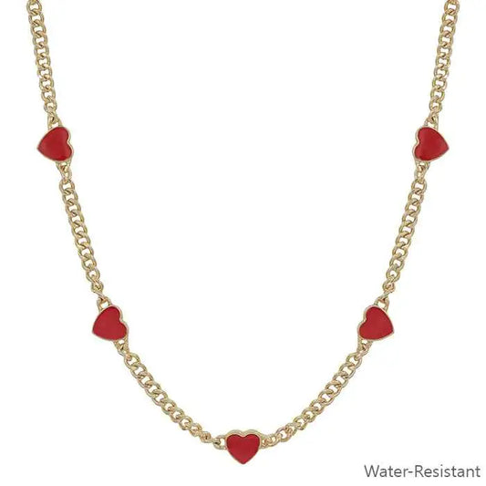 Gold necklace with red heart charms on a white background