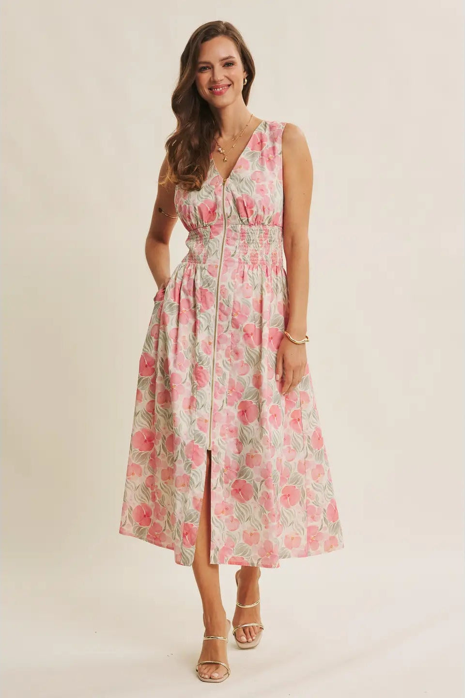 Woman wearing a floral dress on a plain background