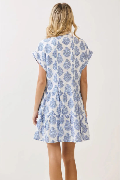 Woman wearing a blue floral dress on a white background