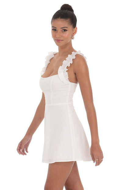 Woman wearing a white dress with floral details on a white background