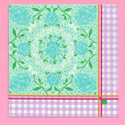A square decorative paper napkin featuring a mint green floral pattern with blue flowers, green leaves, and white dots, finished with a lavender-and-white gingham border and thin orange and magenta stripes.