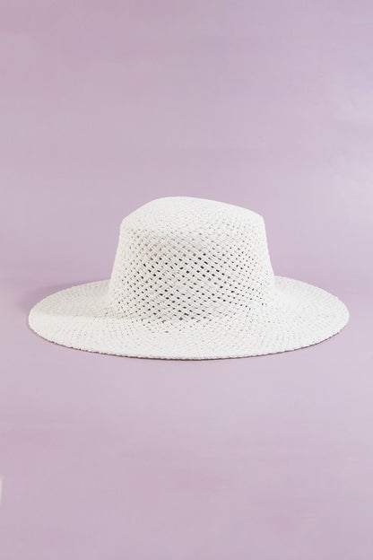 White straw hat on a light purple background