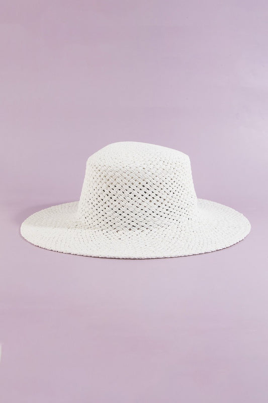 White straw hat on a light purple background