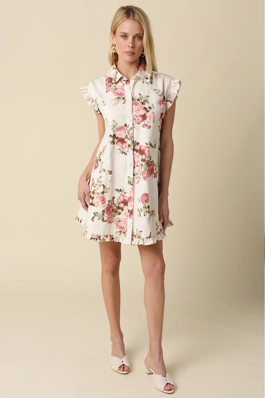 Woman wearing a floral dress against a beige background