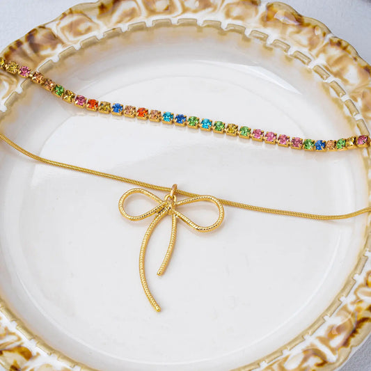 Gold jewelry with colorful stones on a decorative plate