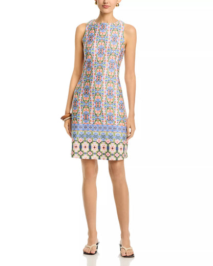 Woman wearing a patterned dress on a white background