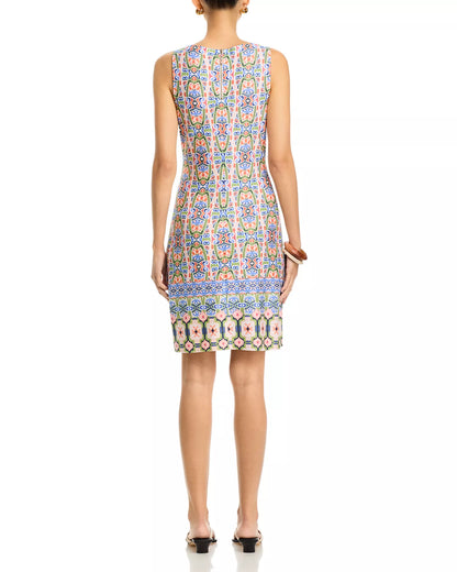 Woman wearing a sleeveless dress with a colorful pattern on a white background