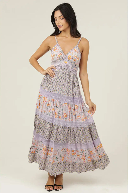 Woman wearing a floral dress on a plain background