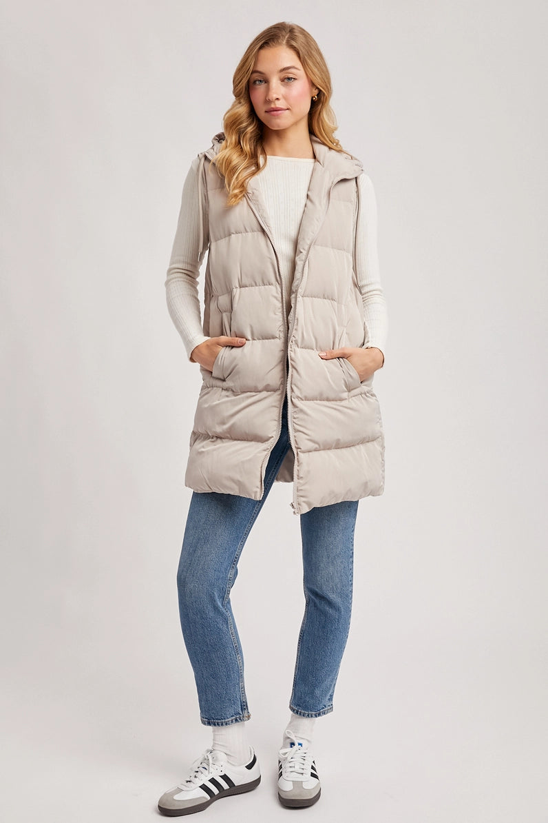 woman in puffer vest and jeans