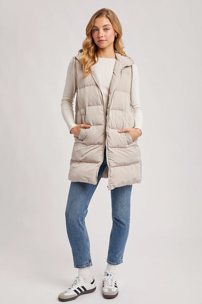 woman in puffer vest and jeans