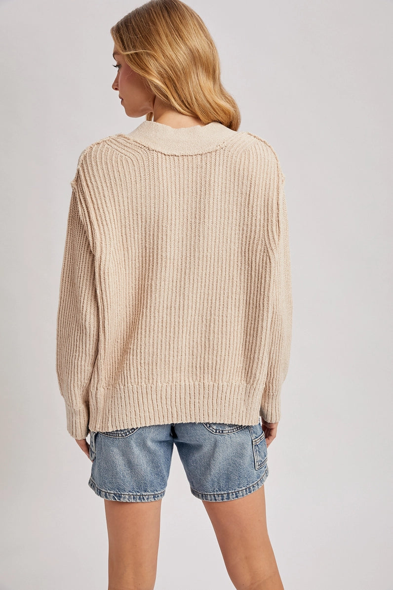 back view of woman in sweater and jean shorts
