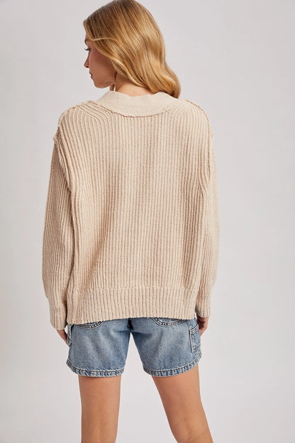 back view of woman in sweater and jean shorts