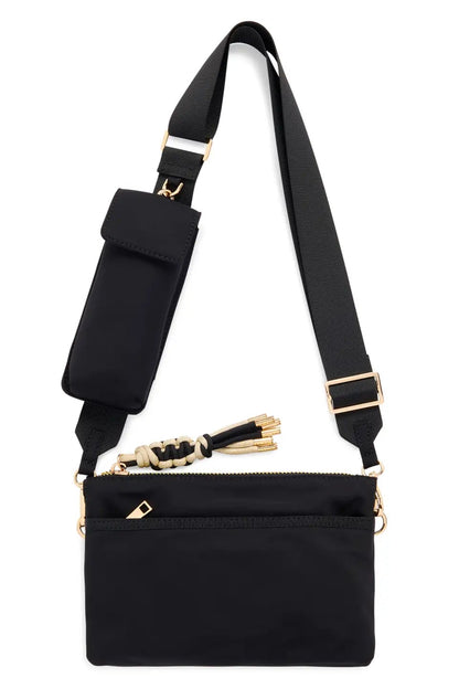 A black nylon crossbody bag with a wide adjustable strap, gold-tone hardware, and a small pouch attachment on the strap, shown against a plain white background.
