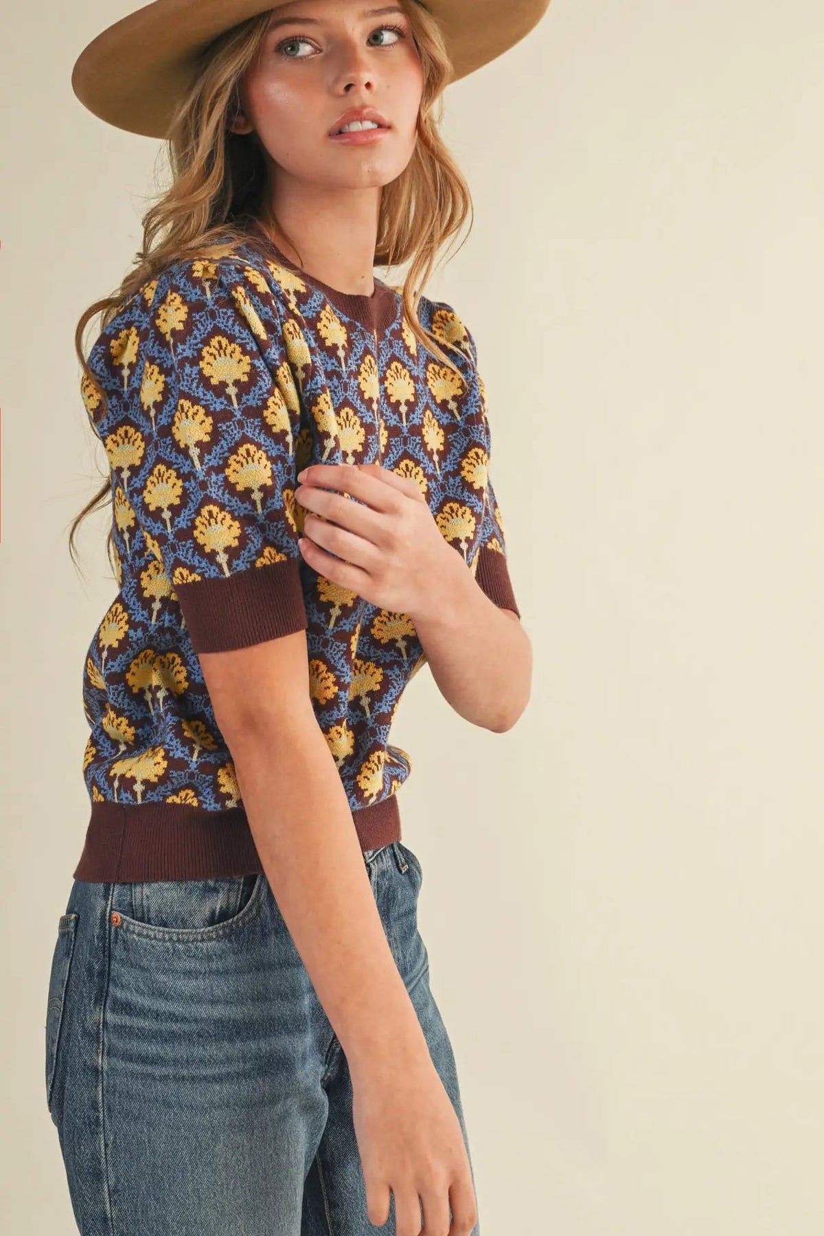 woman in short sleeve floral sweater and jeans