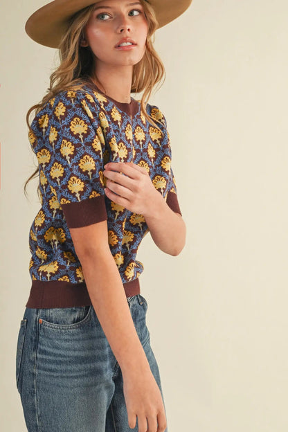 woman in short sleeve floral sweater and jeans