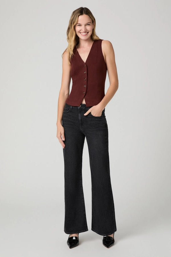 woman in black jeans and red vest 