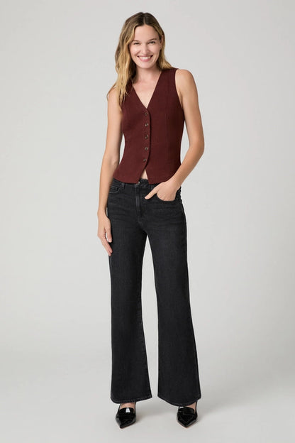 woman in black jeans and red vest 