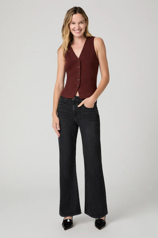 woman in black jeans and red vest 