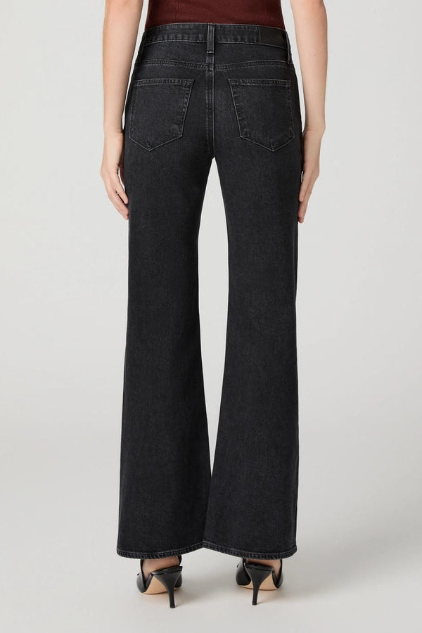 close up of person in black jeans