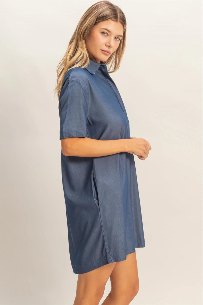 Woman wearing a blue dress against a plain background