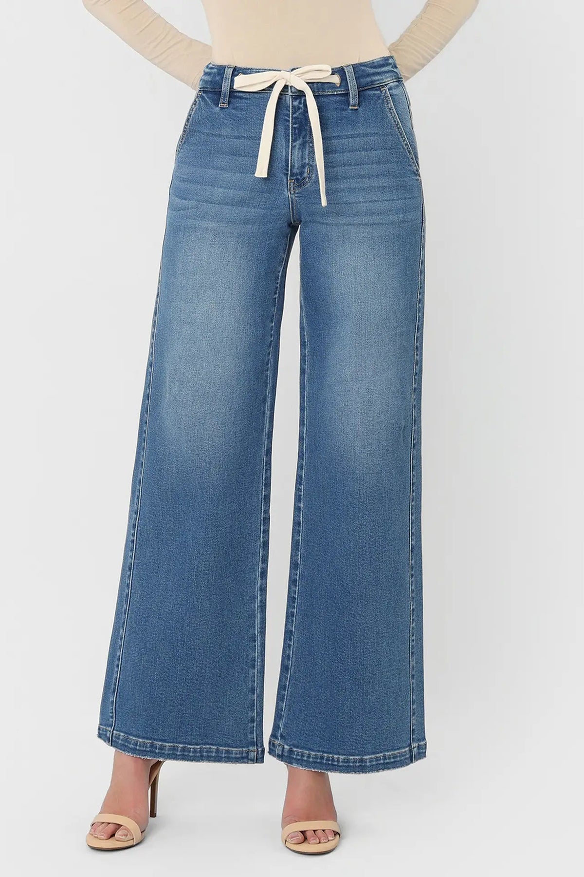 Blue wide-leg jeans with a tie waist on a white background