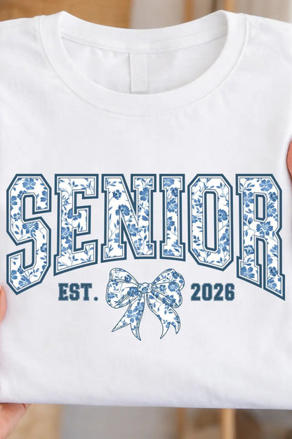 White t-shirt with 'Senior Est. 2026' design held by a person.