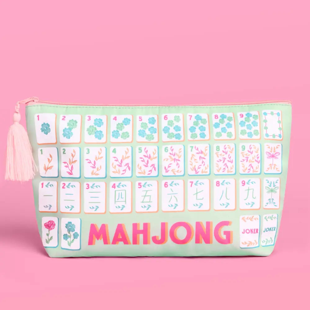 A zippered pouch designed to look like a mahjong set, featuring a mint green background, illustrated tiles, and the word 'MAHJONG' in pink letters, set against a solid pink background.