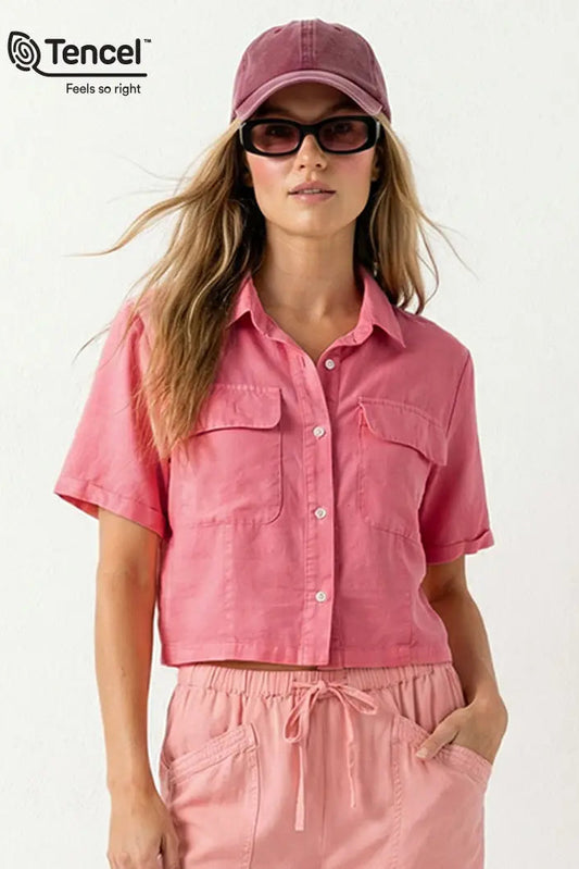 Woman wearing a pink outfit with a matching cap and sunglasses on a white background, featuring Tencel branding.