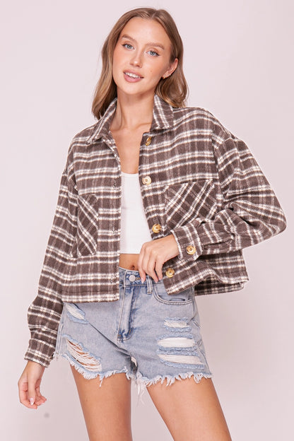 woman in plaid shacket and shorts