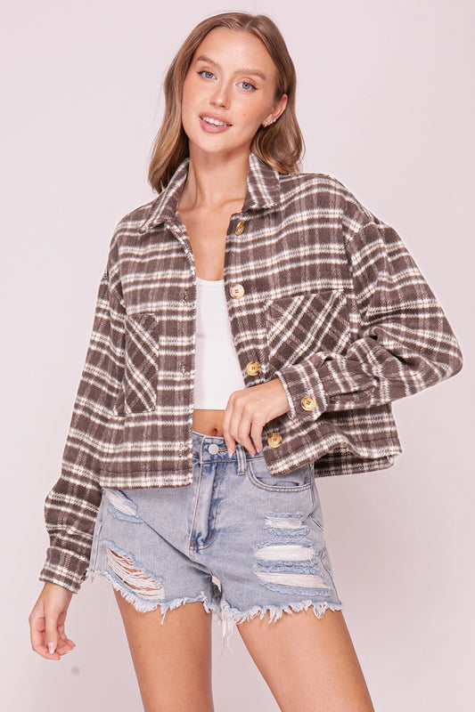 woman in plaid shacket and shorts