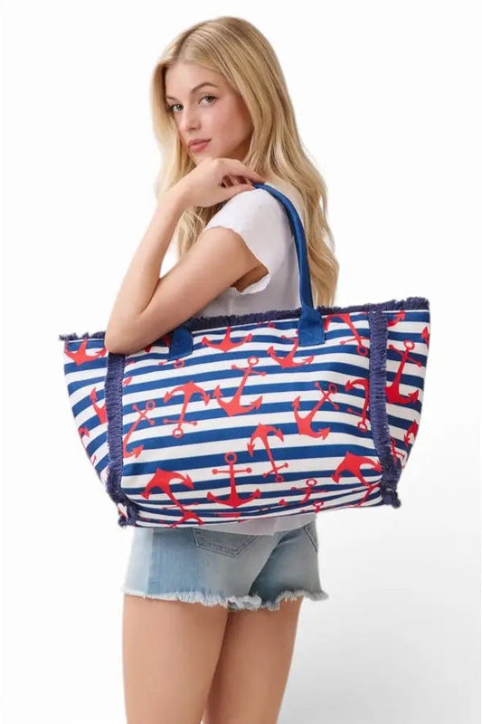Woman holding a large tote bag with anchor pattern on a white background