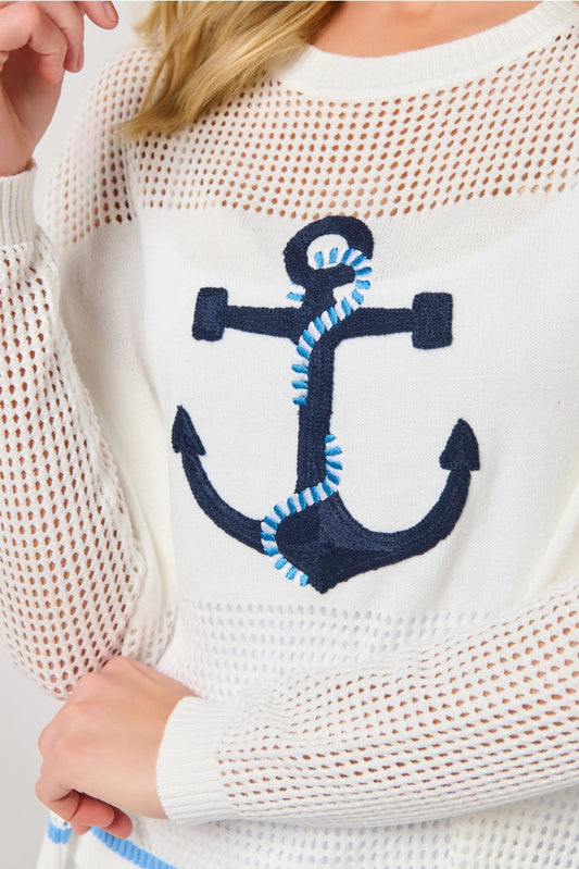 White sweater with a navy anchor design on a plain background