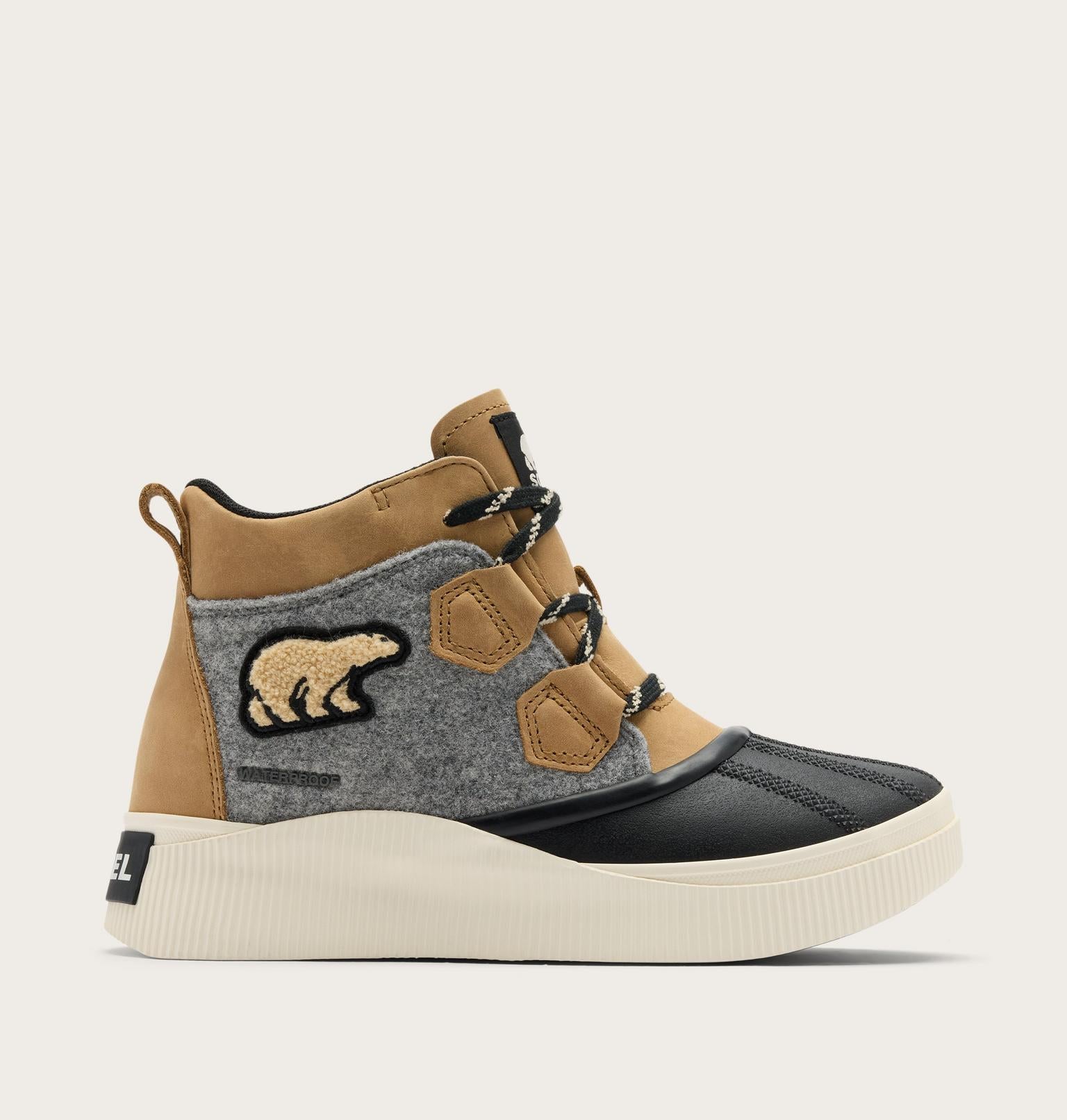 A Diesel mid-top sneaker featuring a tan suede upper, a gray felt side panel with a bear patch, black toe cap, and a thick cream-colored platform sole.