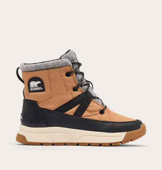 Tan and black winter boot with gray lining on a beige background