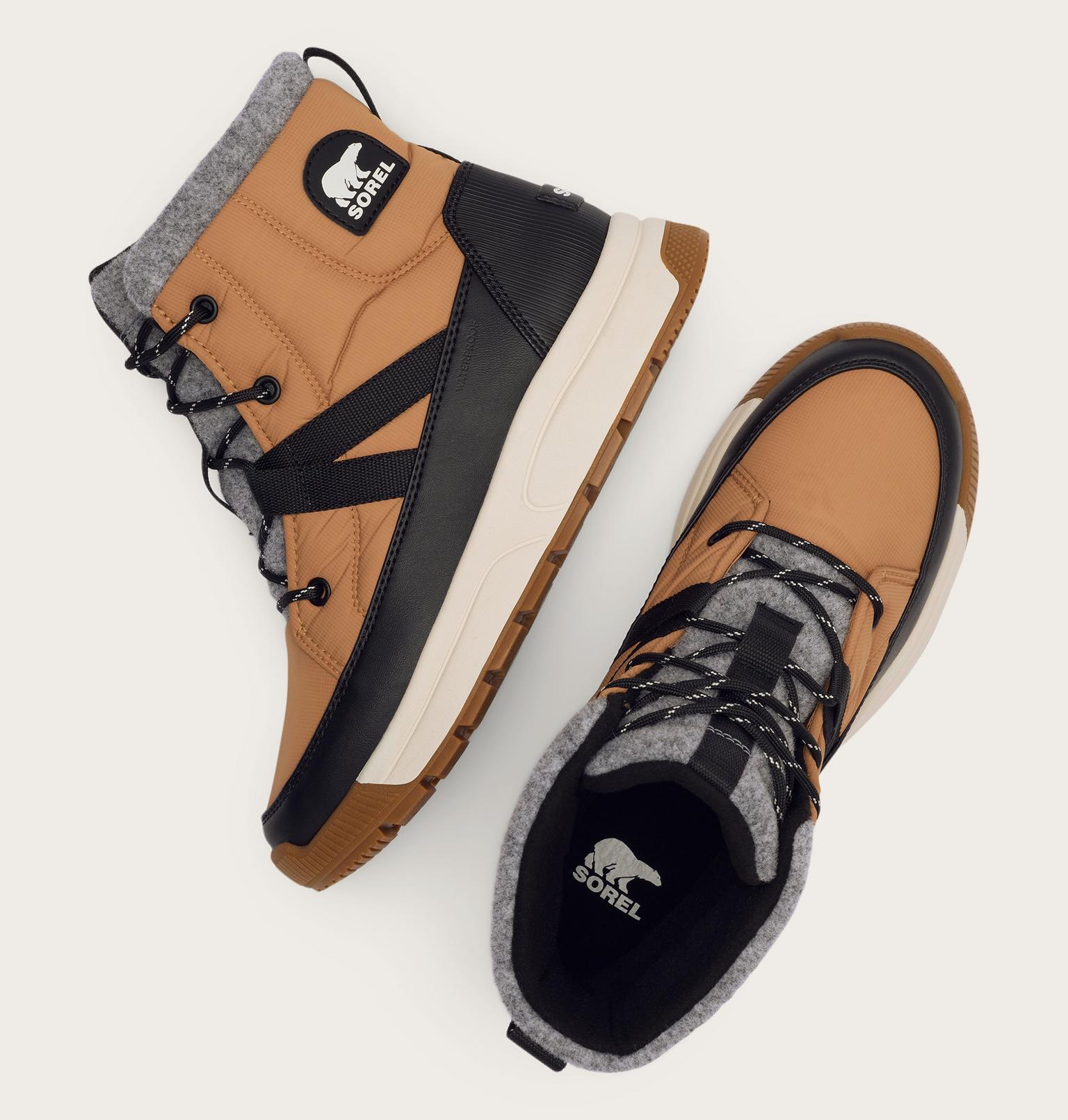 Pair of brown and black boots with gray lining on a white background
