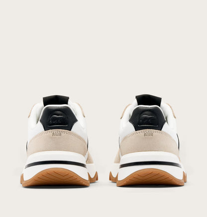 Pair of white and beige sneakers with black accents on a light gray background