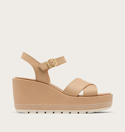 Beige wedge sandal with a platform sole on a light gray background