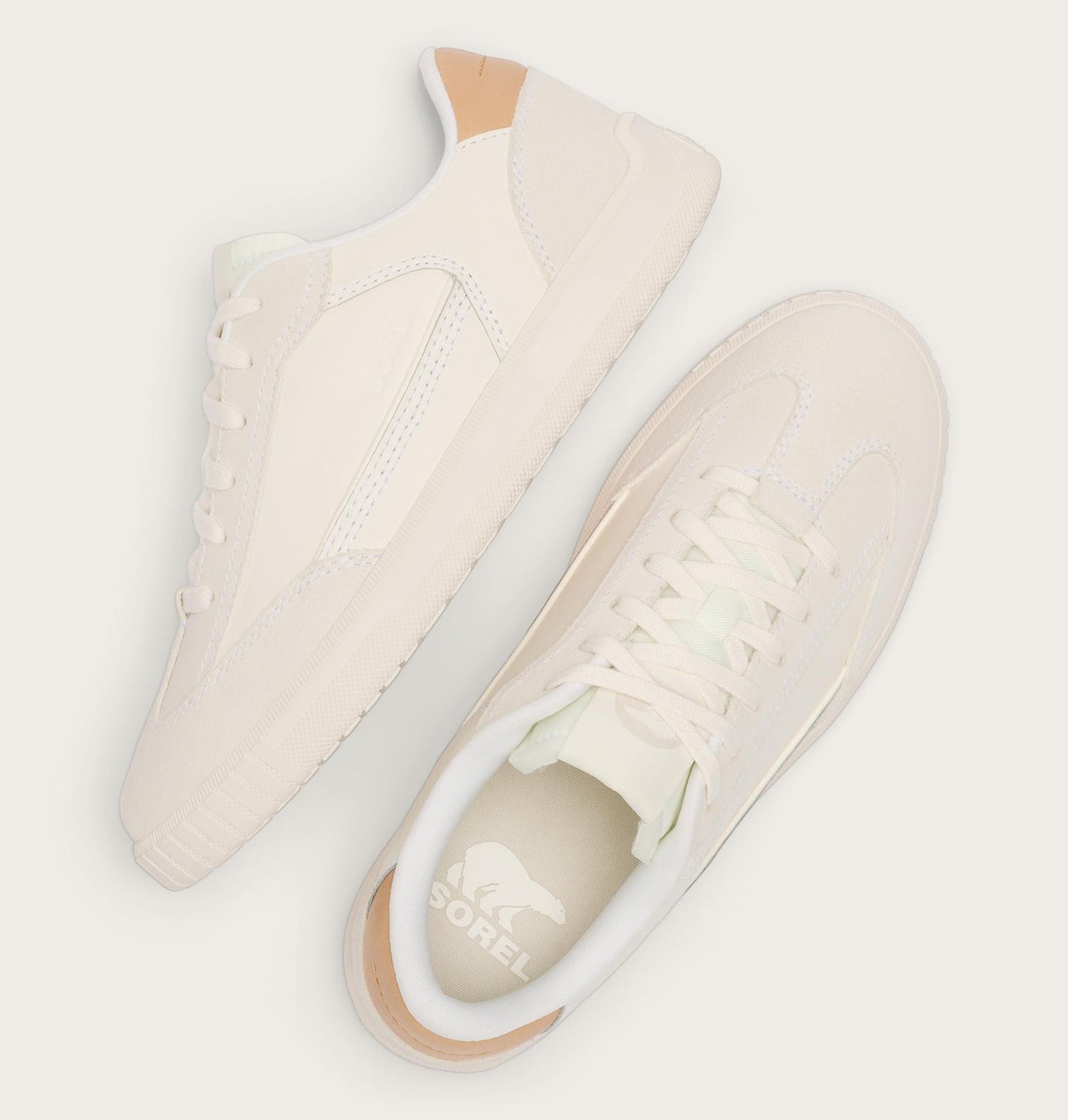 Pair of cream-colored sneakers on a light gray background