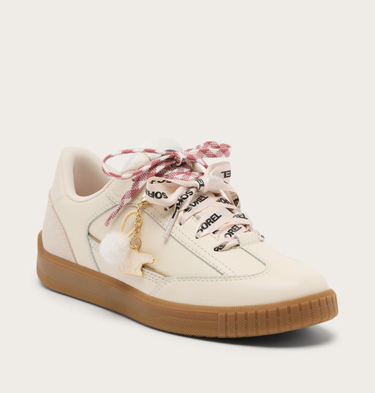 White sneaker with plaid laces and a gold charm on a white background