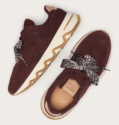 A pair of dark brown suede sneakers with wavy cream and gum soles, featuring leopard-print ribbon laces, shown from multiple angles on a light beige background.
