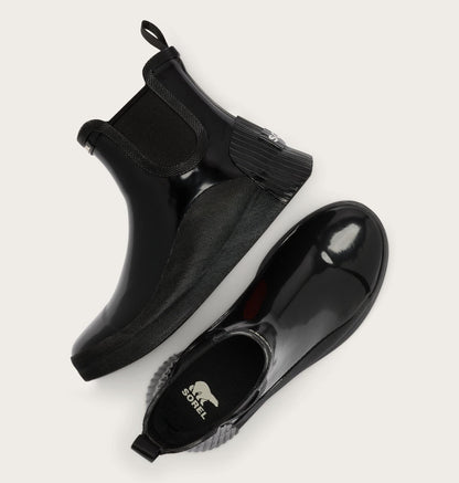 A pair of black rubber Chelsea-style boots with elastic side panels, shown from top and side angles on a light beige background. The brand name 'SALTS BODEL' is visible on the insole.