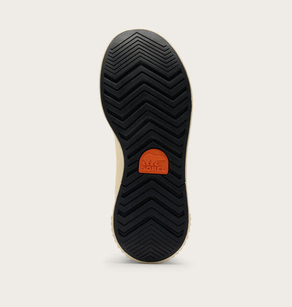 The black treaded outsole of a shoe, showing the SOREL logo in orange on the heel, photographed against a light beige background.