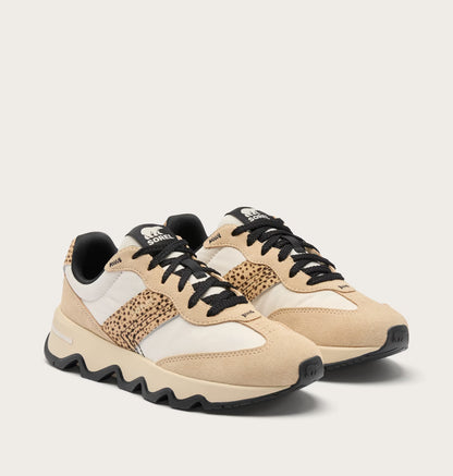 Beige and black sneakers with a patterned sole on a light beige background