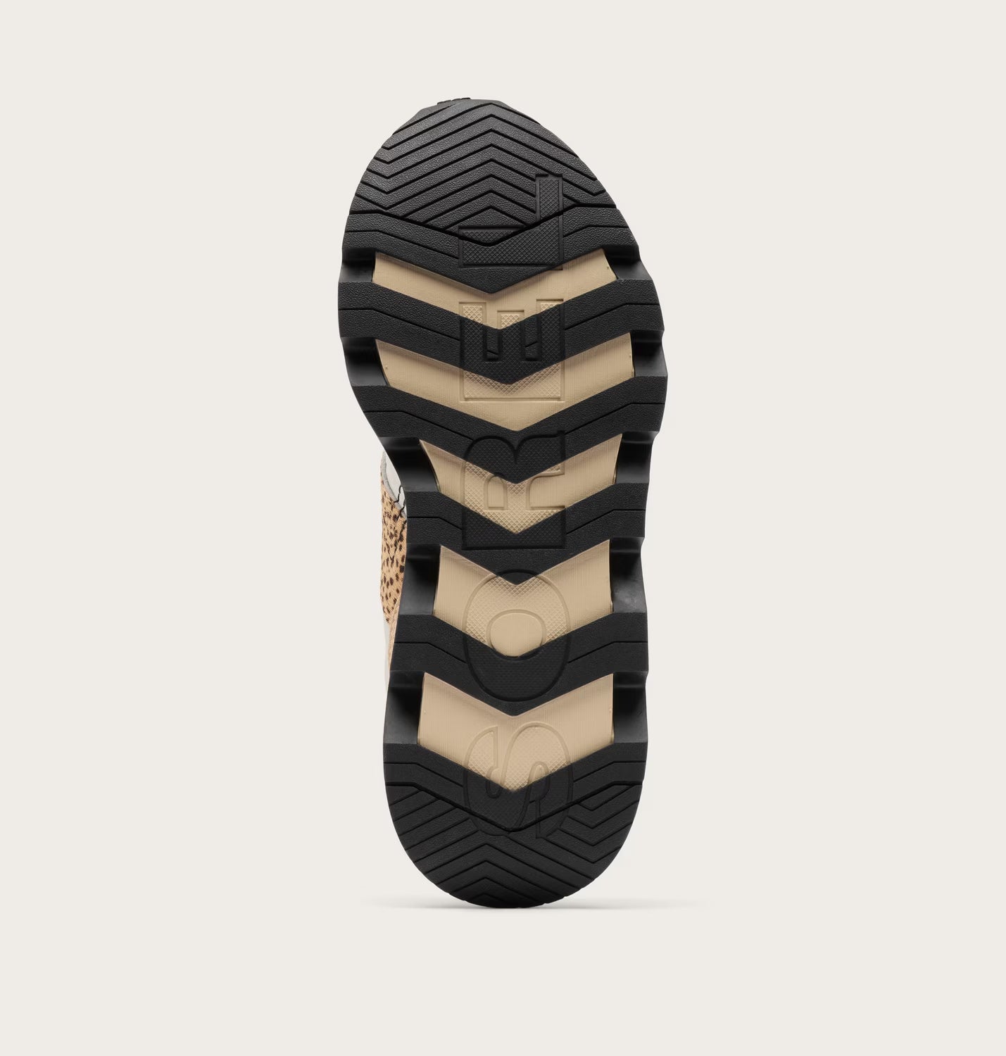 Close-up of a shoe sole with a textured pattern on a light gray background