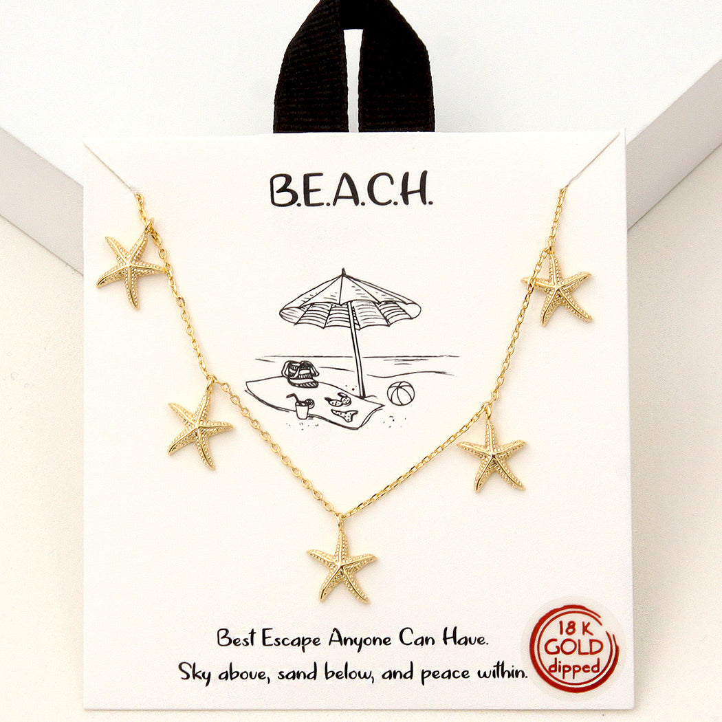 Gold starfish necklace on a 'B.E.A.C.H.' branded card with beach illustration